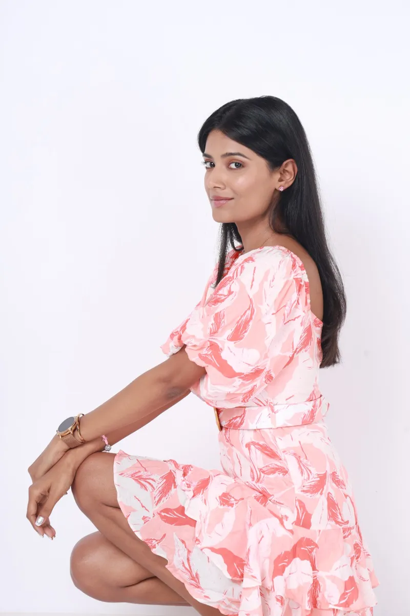 Snehal Patil in a pink floral dress, studio photograph