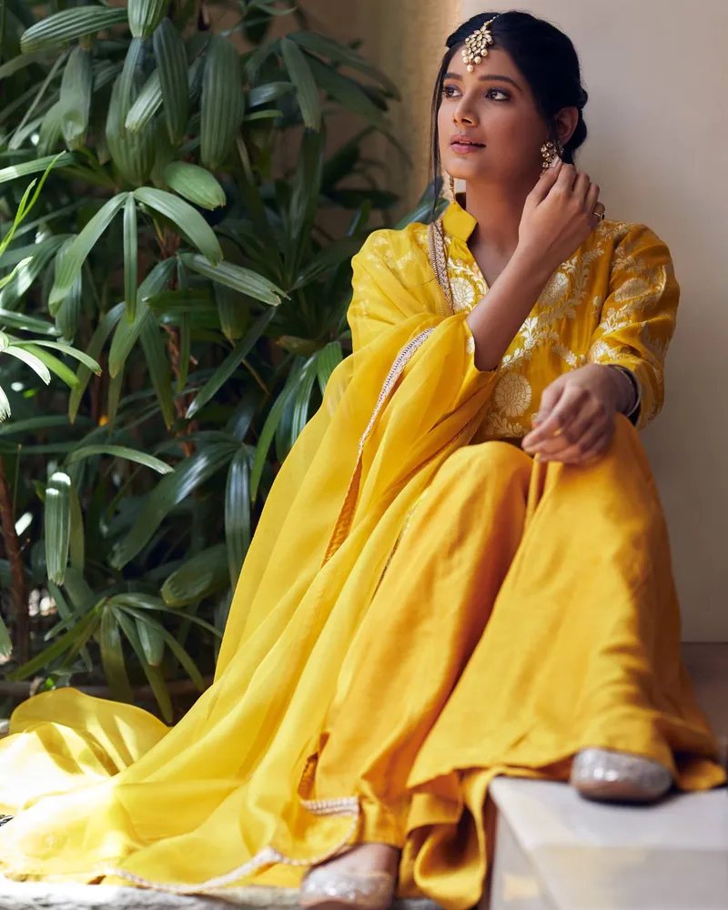 Snehal Patil in a yellow outfit with a sheer dupatta