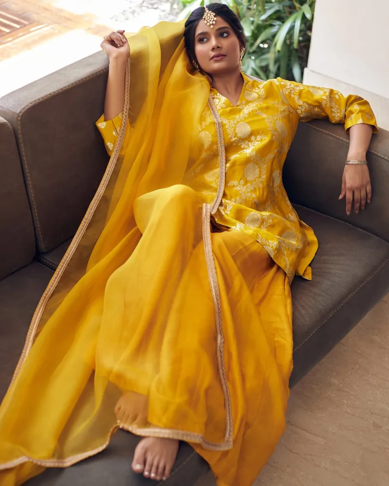 Snehal Patil in a yellow outfit with a sheer dupatta